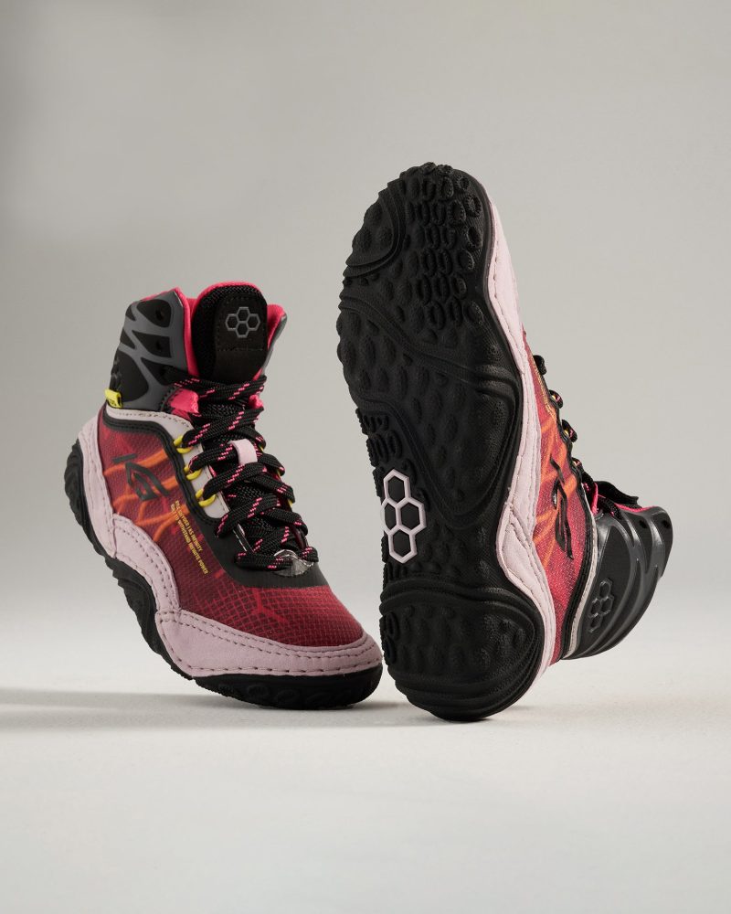 A pair of vibrant multi-colored athletic shoes with a unique design and textured soles positioned for emphasis on their features