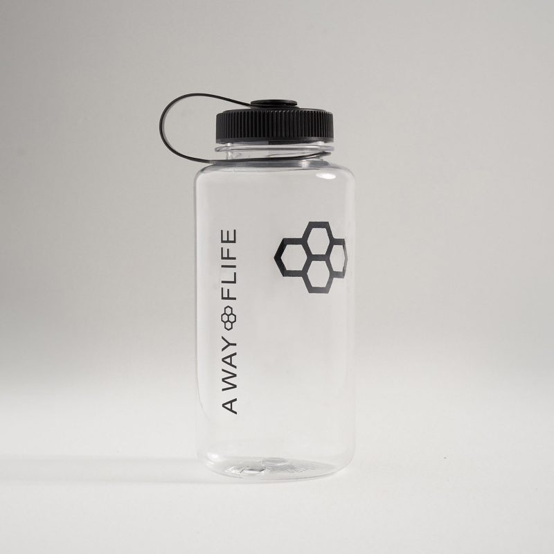 A stylish clear water bottle featuring a black screw-on lid and a minimalist design with the text A WAY OF LIFE and a hexagonal logo