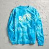 A vibrant blue tie-dye sweatshirt featuring the bold text BLADES WRESTLING printed in yellow along with a logo on the sleeve