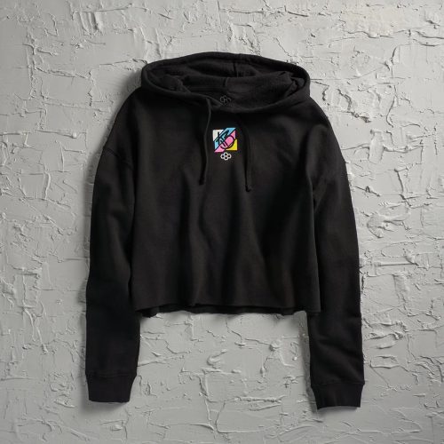 A stylish black cropped hoodie featuring a colorful graphic design on the chest against a textured white background