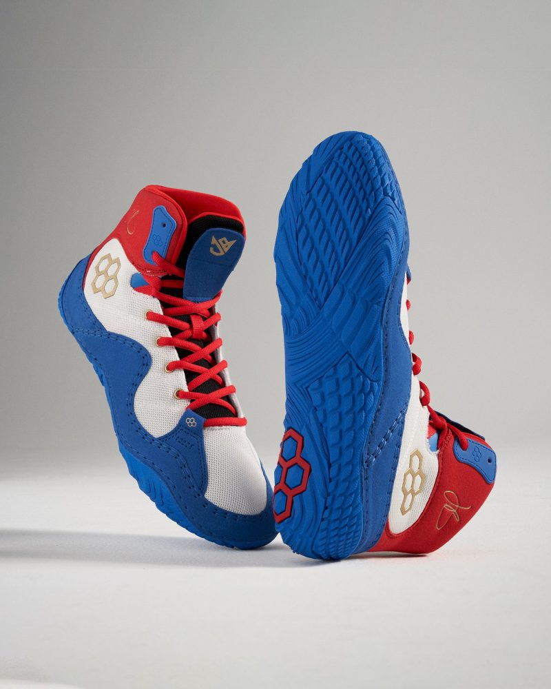 A vibrant pair of athletic shoes featuring a blue white and red color scheme designed for both performance and style with distinct detailing throughout