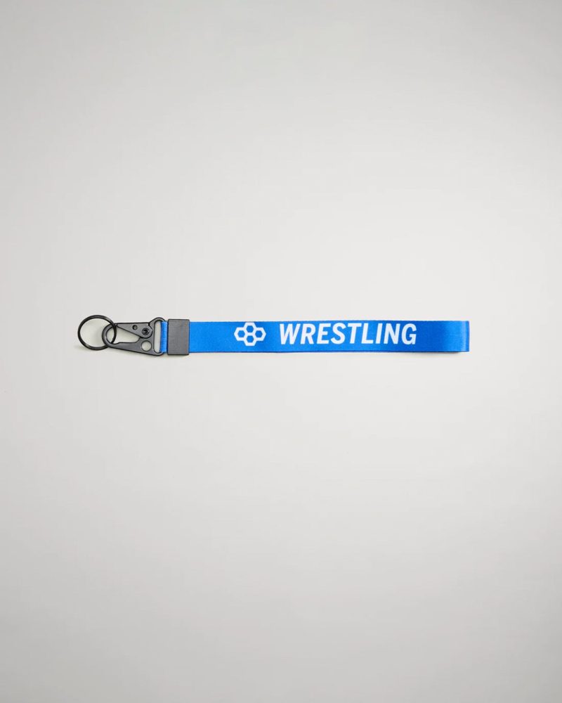 A vibrant blue wrestling keychain featuring the word WRESTLING in bold white letters and a black clip for attachment