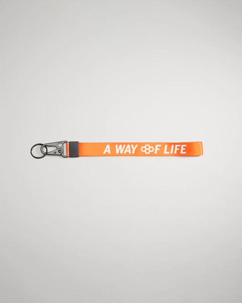 An orange lanyard featuring the phrase A WAY OF LIFE in white lettering with a metal clip and keyring attachment for versatility