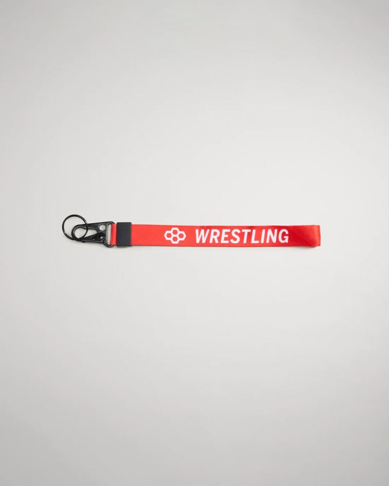 A vibrant red lanyard with the word WRESTLING printed in white featuring a black clip for attaching keys or ID cards