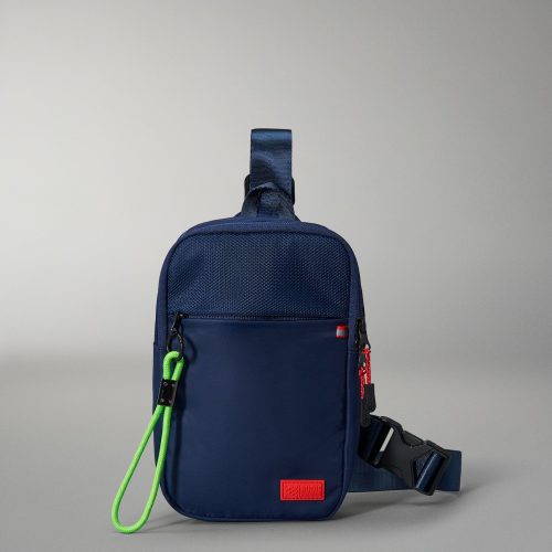 Compact navy sling bag with a textured surface, neon green pull strap, and an adjustable strap for crossbody wear, designed for daily use.