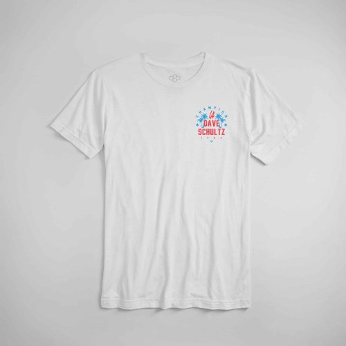 A white cotton t-shirt featuring a colorful graphic design that honors Dave Schultz a prominent figure in wrestling with the year of his recognition 1984