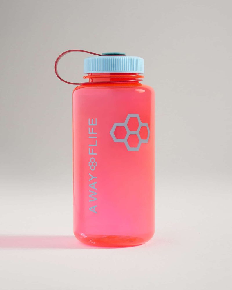 A vibrant pink water bottle with a light blue cap featuring the words A WAY OF LIFE and a honeycomb design