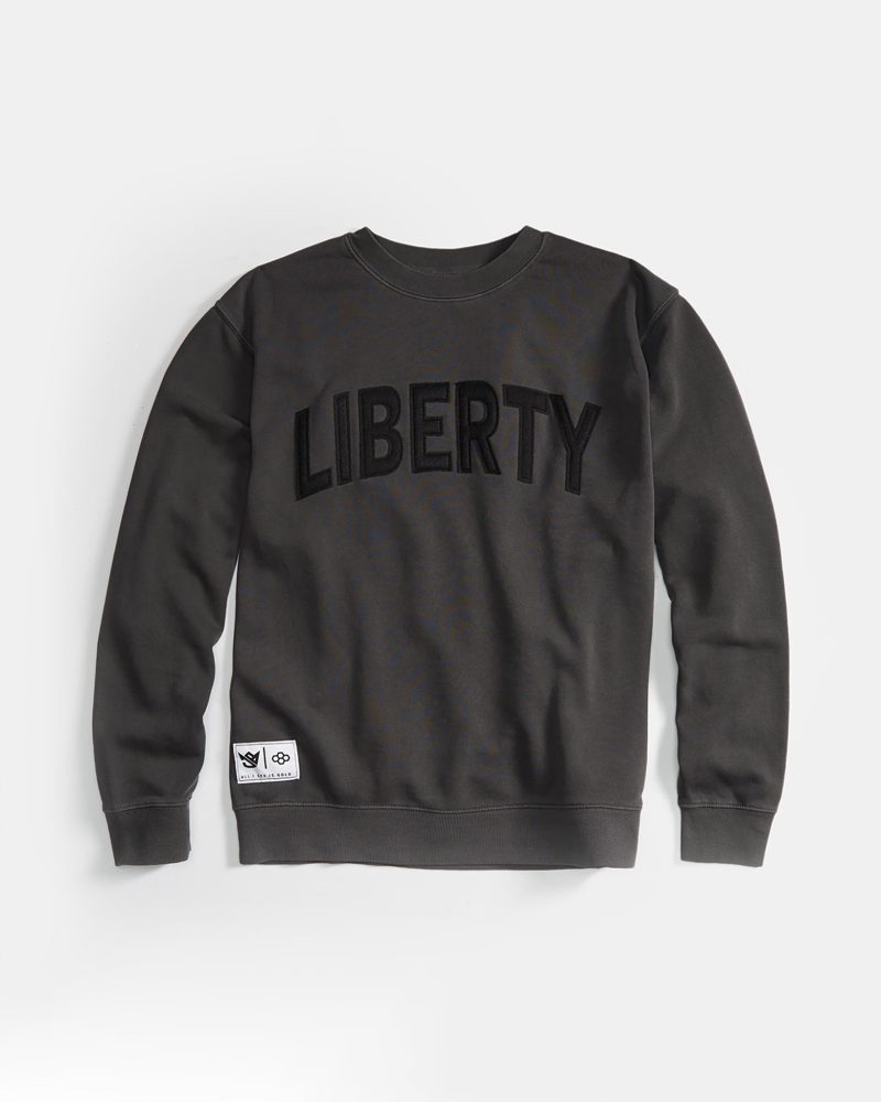 A dark green sweatshirt featuring the bold word LIBERTY prominently displayed across the front complemented by a small logo on the bottom left corner